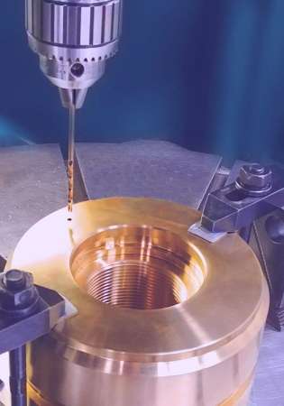 Bronze hydraulic cylinder piston for critical defense application on mill in process of being machined
