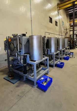 Four hydraulic power units for lock dam gates in shop being prepared for test before delivery to project site.