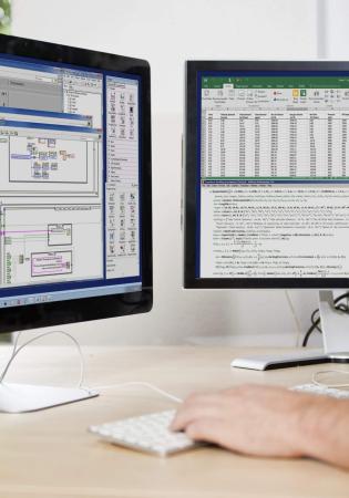 Two computer screens on desk with various windows showing custom hydraulics design work in progress.