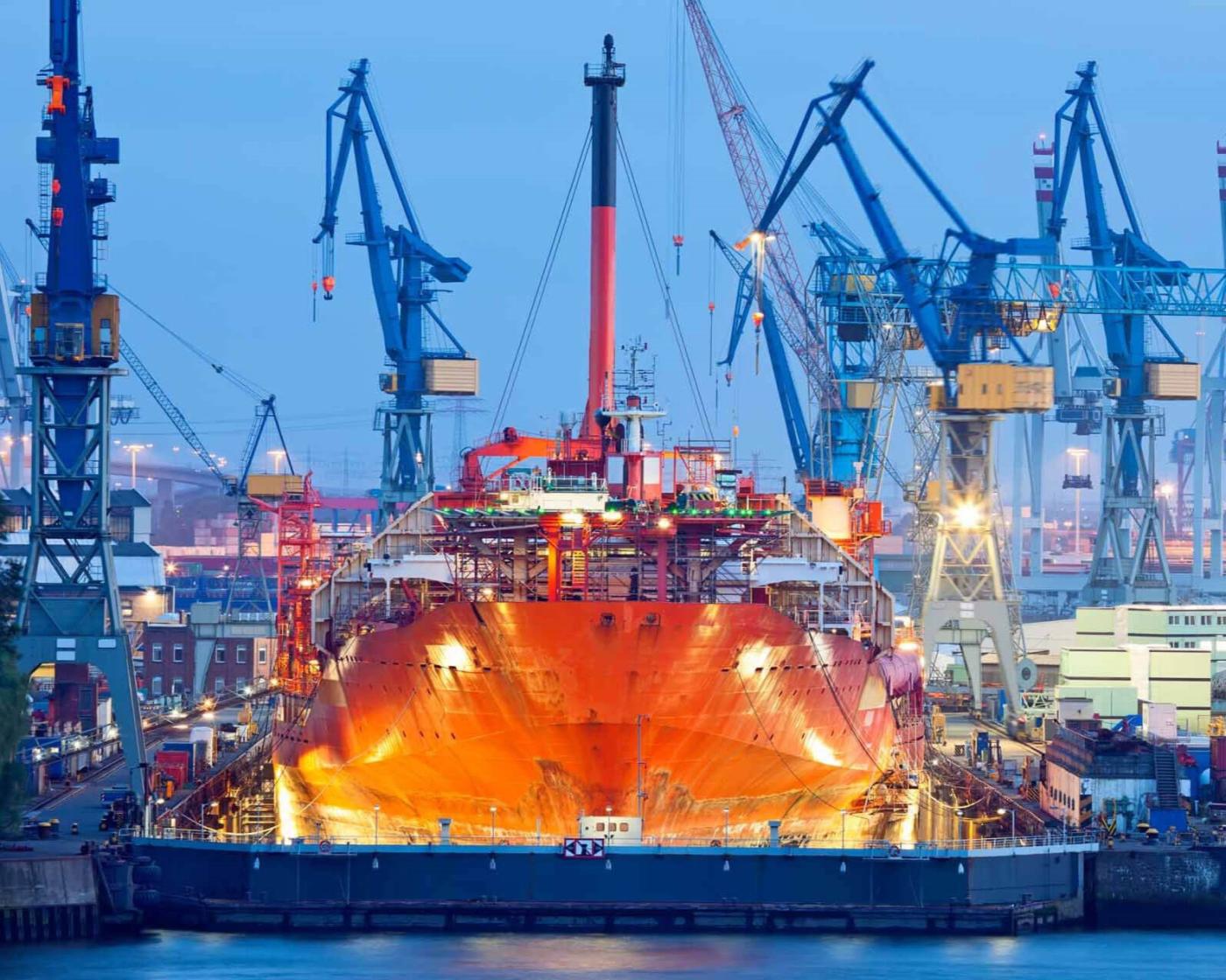 Ship in drydock surrounded by cranes; a heavy industrial environment where heavy duty hydraulic cylinders are prolific.