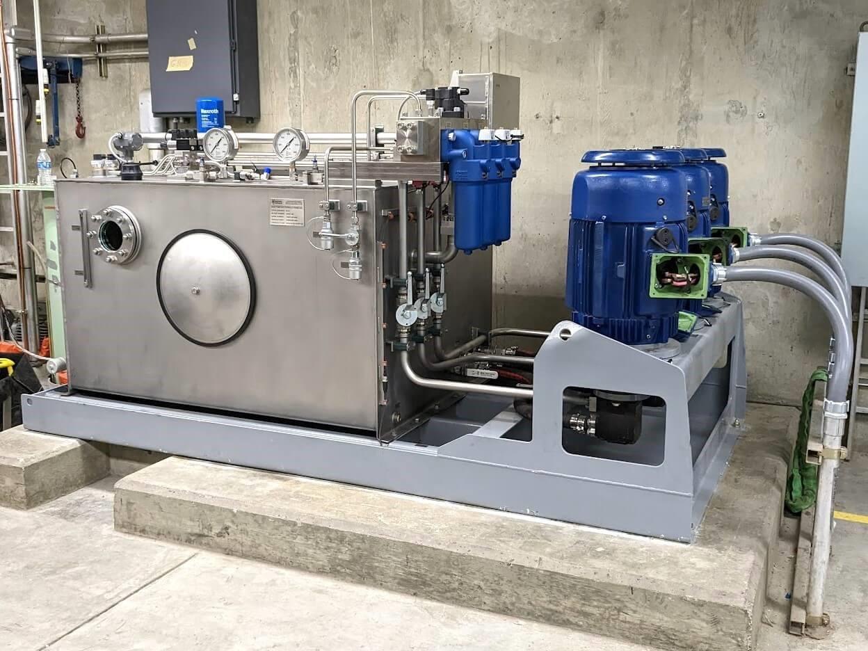 Custom hydraulic power unit with stainless steel reservoir at hydroelectric dam.