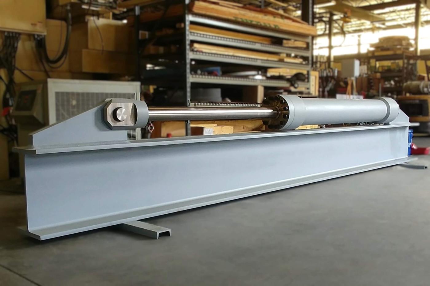 Nickel alloy marine hydraulic cylinder for naval combatant on load test fixture in shop 
