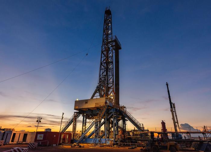 Land drill rig at sunset