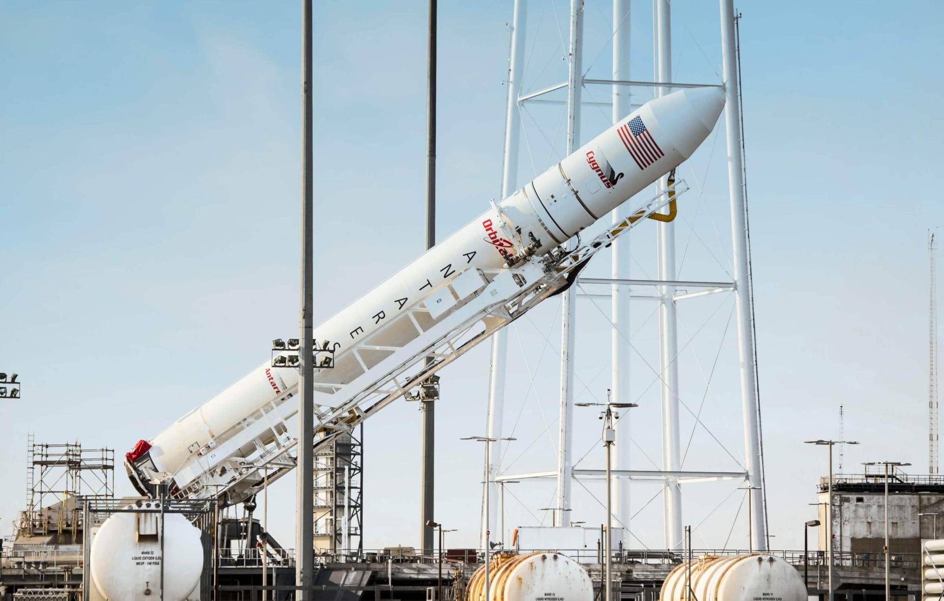 Antares rocket on TEL at pad 0A being lifted from horizontal to vertical with large custom hydraulic cylinders.