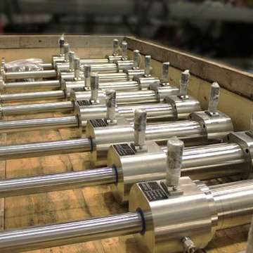Subsea stainless steel, double rod custom cylinders being prepared for shipment in a crate