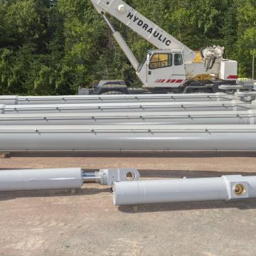 Civil engineering hydraulic cylinders in yard ready to be loaded for delivery
